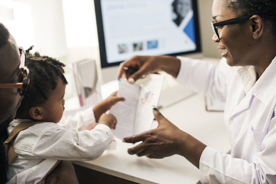 Employee Benefits - Young Mother and Child Receiving Patient Information From a Pediatrician